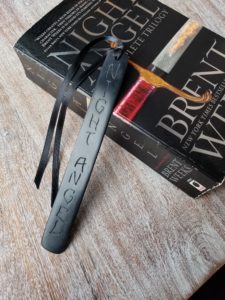 black bookmark with black ribbon and the words Night Angel etched into it