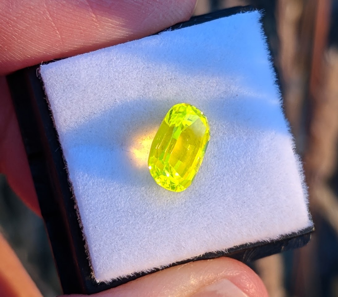 Small faceted yellow oval gemstone